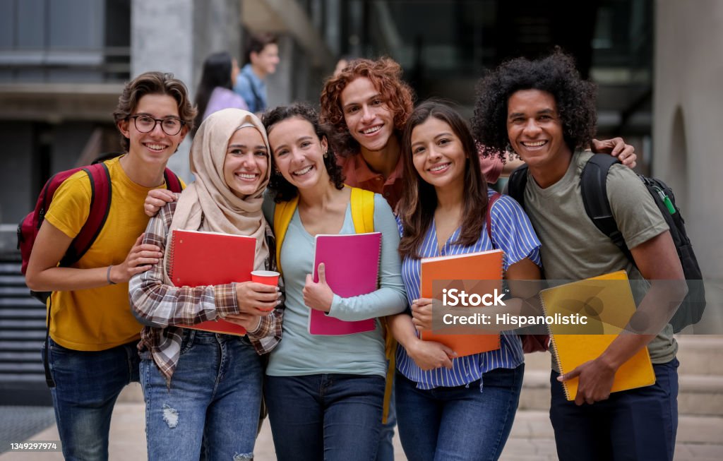 Group of college students enjoying their time between two lectures on the university campus.