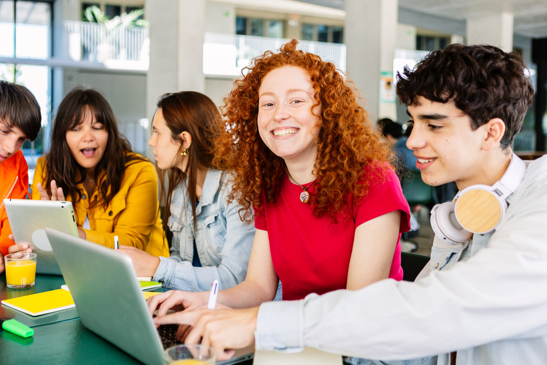 Happy young group of students studying together and working together with laptop at cafeteria in campus college.